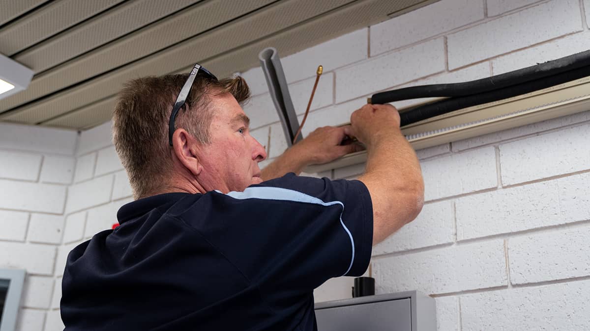 This installation of your split AC system has pipes going through the roof of your property.