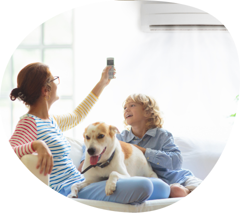 female sitting with dog and son underneath air conditioner